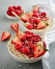 Porridge bowls with berries, pomegranate seeds and puffed quinoa — Stock Photo