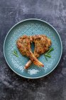 Roasted Lamb chops with rosemary on blue plate — Stock Photo