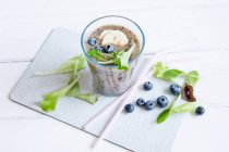 A blueberry smoothie with mixed leaves — Stock Photo