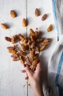 A hand holding date bunches — Stock Photo