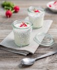 Herb quark with radishes in jars — Stock Photo