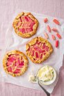 Rhubarb and almond galette with clotted cream, view from above. — Stock Photo