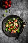 Ensalada con fresas alucoumi rúcula hojas de rábano y salsa balsámica - foto de stock
