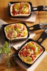 Mini, oven-baked raclette pizzas with cheese and vegetables — Stock Photo