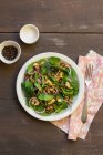 Spinach salad, red onions, lentils and walnuts, black pepper, salt — Stock Photo