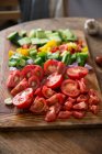 Chopped gazpacho vegetables on a wooden board — Stock Photo