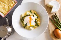 Cuscus with asparagus, blue cheese and poached egg — Stock Photo
