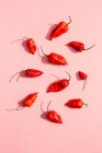 Fresh red chili peppers on a pink background — Stock Photo