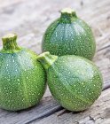 Round zucchini on a wooden background — Stock Photo