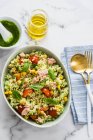 Rice salad with pesto and tuna, cutlery on napkin — Stock Photo