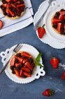 Mini tarta con mermelada de fresa, servida con fresas frescas y ganache de chocolate - foto de stock