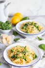 Pasta with spinach, peas and lemons on background — Stock Photo