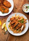 Chicken escalope with pasta salad and greens — Stock Photo