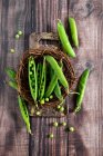 Fresh green peas on the table — Stock Photo