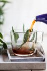 Meramieh tea (black tea with fresh sage) is poured into a cup — Stock Photo