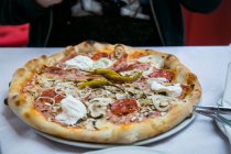 Pizza with burrata and salami — Stock Photo