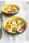 Colourful fruit salad in an orange and mint sauce — Stock Photo