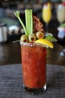 Bloody mary with olives, celery and bacon — Stock Photo