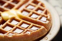 Whole belgian waffle with syrup and butter — Stock Photo