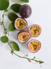 Purple passion fruits, whole and halved — Stock Photo