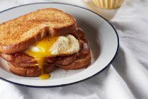 Сэндвич с яйцом, нарезанным ветчиной и желтком — стоковое фото