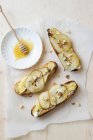 Toasts with camembert cheese, pears, walnuts and honey — Stock Photo