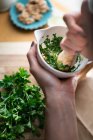 Pesto verde with parsley and mint being made in a mortar — Stock Photo