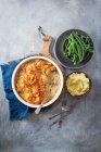 Chicken, leek and mushroom pie with filo pastry top, mashed potatoes and beans — Stock Photo