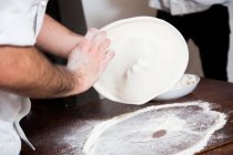 Preparing Pizza - Flatten and shape the dough — Stock Photo