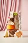 Cheese still life with salami and baguette — Stock Photo