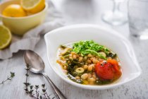 Bean soup with cabbage, tomatoes, lemons and thyme — Stock Photo