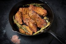 Roasted seitan in cast iron pan with various herbs and spices — Stock Photo