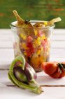 Young pickled artichokes with tomatoes, peppers, vinegar, oil, lemon, white wine and spices — Stock Photo