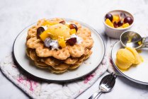 Vegan vanilla waffles with mango sorbet, soya cream and fruit — Stock Photo