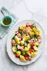 Potato and tuna salad with eggs and dressing in mini bowl — Stock Photo