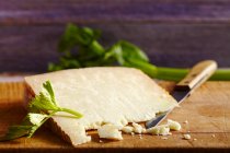 Pecorino sardo, hard cheese made from sheep's milk on wooden board with knife — Stock Photo