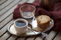 Espresso with oat biscuits and water — Stock Photo