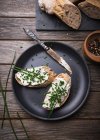 Spelt baguette with almond cream cheese and chives — Stock Photo