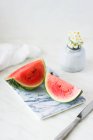 Watermelon wedges on marble chopping board — Stock Photo