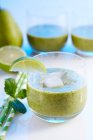 Glasses of green smoothies with pear, banana and spinach — Stock Photo