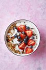 Muesli yoghurt bowl with berries and coconut flakes — Stock Photo
