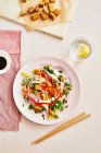 Ensalada de tempeh asado asiático con cebolla roja, cilantro, pimiento rojo, cebolla de primavera y zanahoria rallada - foto de stock