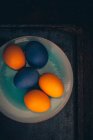 Easter eggs colored with organic dyes on plate — Stock Photo