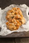 Fresh baked popcorn cookies in baking paper — Stock Photo