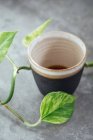 Black coffee in a handmade black clay cup — Stock Photo