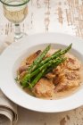 Pork with shallots and asparagus — Stock Photo