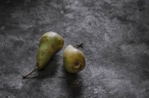 Homegrown pears on rustic concrete surface — Stock Photo