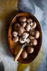 Champignons in large wooden bowl with knife — Stock Photo