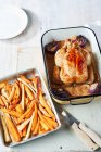 Lemon roast chicken with orange maple roasted roots — Stock Photo