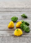 Mini yellow and green patty pan squash on a rustic wooden table — Stock Photo